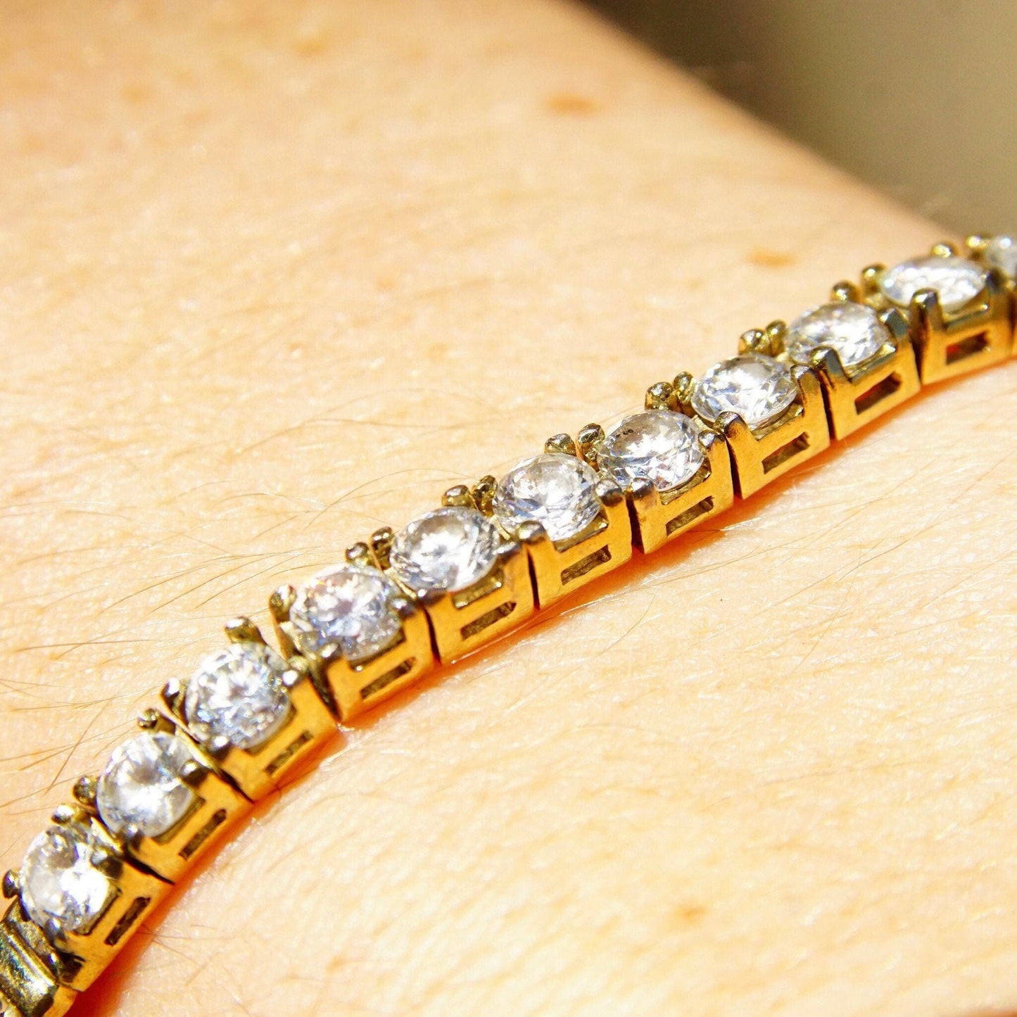 Vintage gold plated sterling silver cubic zirconia diamond bar bracelet with 2.5mm herringbone chain and 12 brilliant CZ diamonds, measuring 7 1/8 inches long.