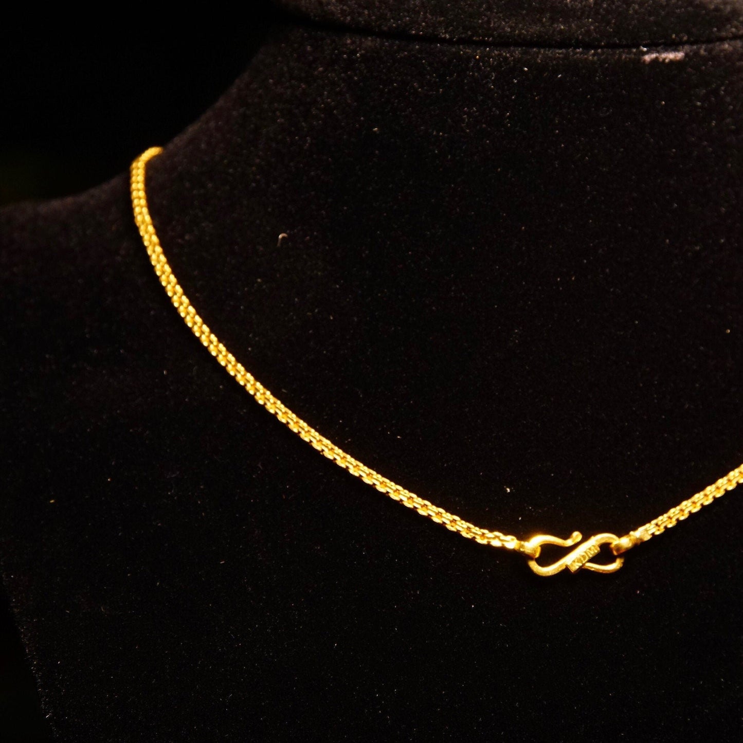 Vintage 22K yellow gold Bombay Bismark chain necklace on black background, minimalist flat 2mm fence link choker made in India by KDM, 16.25 inches long.