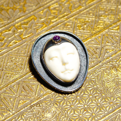 Vintage Sajen sterling silver pendant featuring a carved bovine bone moon goddess and amethyst on a textured golden background, unique extraterrestrial-themed 925 jewelry piece measuring 1 1/2 inches.