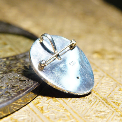Close-up of the back of a Sajen style sterling silver pendant featuring a pin and clasp mechanism, elegantly crafted with unique 925 jewelry markings.