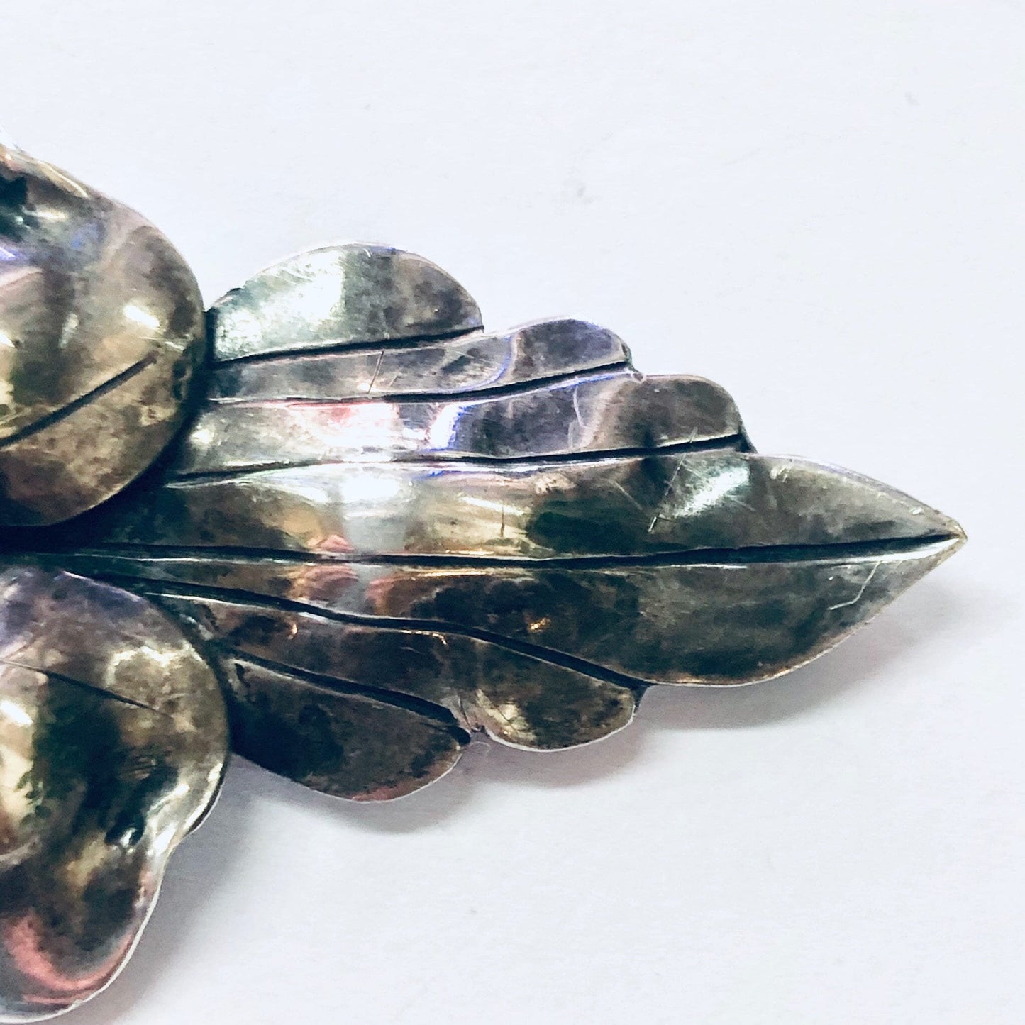 Vintage silver flower brooch pin with layered petals in an oxidized finish, likely from John Wanamaker jewelry collection, displaying intricate metalwork and unique design.