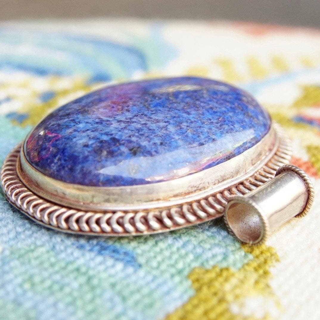 Vintage modernist lapis lazuli sterling silver pendant featuring a large, marbled blue oval lapis stone set in an ornate ribbed silver setting, measuring approximately 2 1/2 inches long by 2 3/4 inches wide.