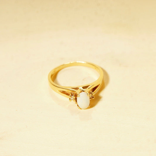 14K yellow gold solitaire ring with an oval opal center stone and small diamond accents on the shoulders, size 6 1/4 US, estate jewelry perfect for an October birthstone gift.