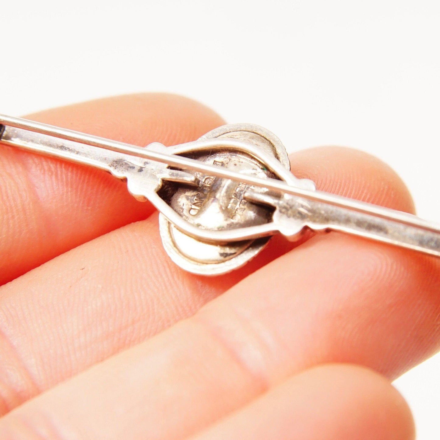 Antique Art Deco sterling silver bar pin from England, featuring a small figural sulphide butterfly wing cameo with floral details and engraved accents, measuring 1 3/8 inches in length.