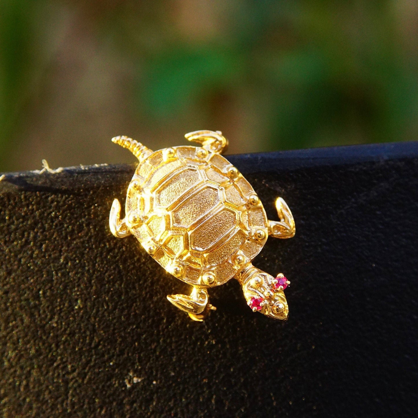 Vintage 14K yellow gold turtle brooch with ruby eyes, small ruby gemstones adorn the shell, animal-themed jewelry pin in 585 gold