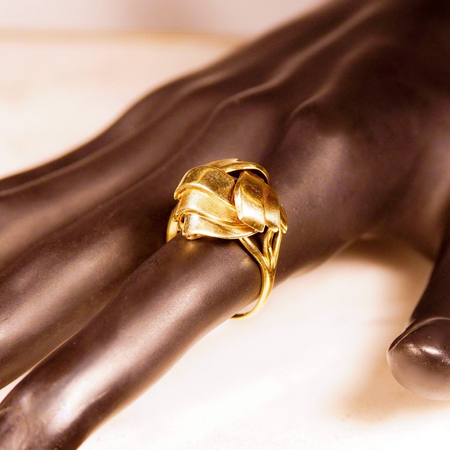 Vintage 585 yellow gold dome ring with abstract swirl ribbon wreath design, chunky gold band, size 8 3/4 US, close-up view on brown satin fabric background