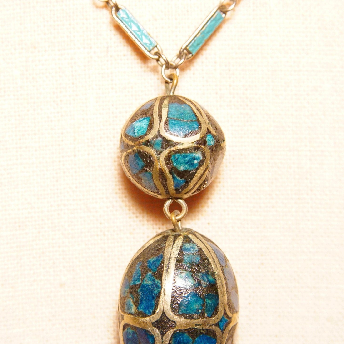 Vintage Indian mosaic turquoise brass inlay bauble pendant necklace featuring a two-bead drop pendant with intricate blue enamel inlays set on an 18-inch long silver link chain.