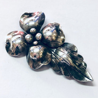 Vintage silver flower brooch pin with textured petals and small silver balls, likely from John Wanamaker jewelry collection, providing a unique and eye-catching accessory from the 925 silver collection.