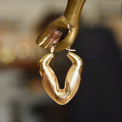 14K yellow gold puffed V-shaped hoop earrings with line texture, hinged ear wire, small to medium size, 1 3/8 inches long.