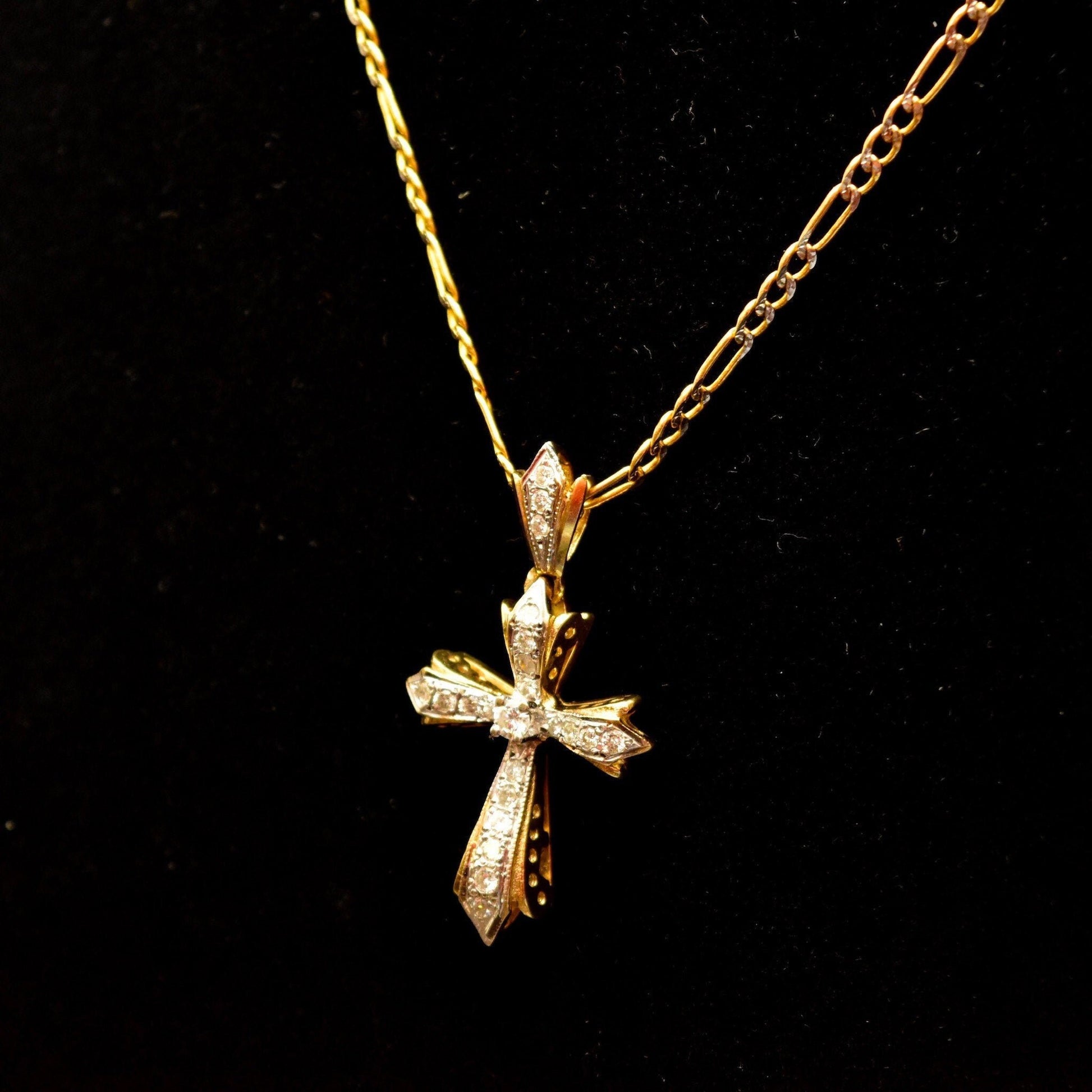14K gold diamond-encrusted gothic cross pendant necklace with two-tone diamond cut Figaro chain, vintage religious jewelry, 16 inches long, on black background