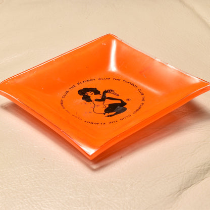 Vintage orange glass Playboy Club ashtray featuring Leroy Neiman Femlin artwork from the 1960s, small 4.75 inch square trinket dish