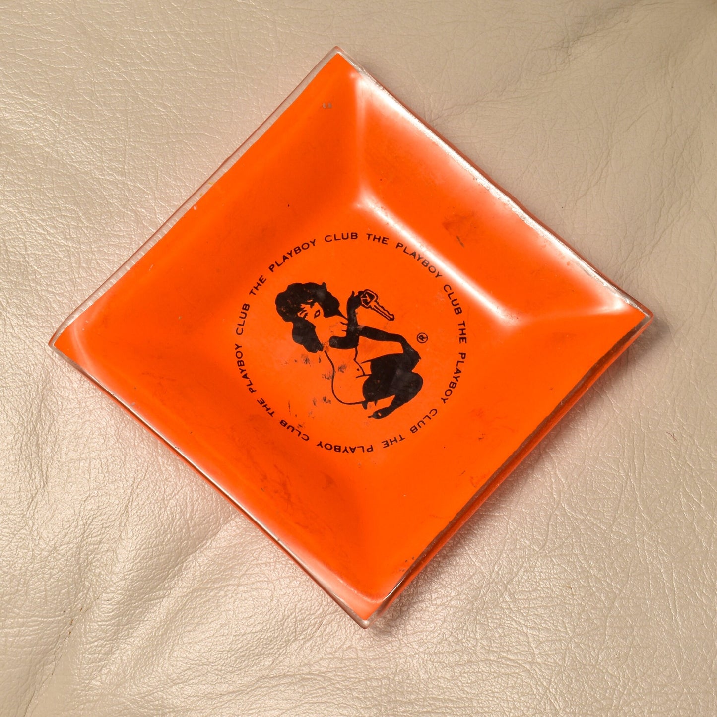 Vintage 1960's orange glass Playboy Club ashtray featuring Leroy Neiman Femlin illustration, small 4.75" square trinket dish