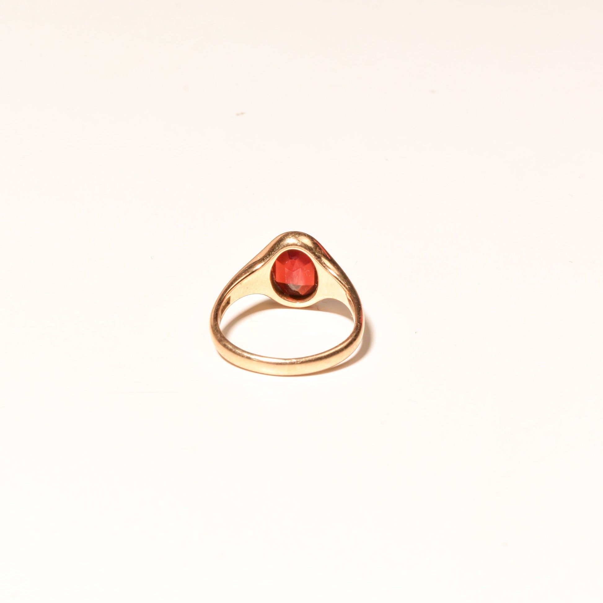 14K yellow gold signet ring featuring a round cabochon garnet, minimalist design, suitable as a men's pinky ring, size 7 US.