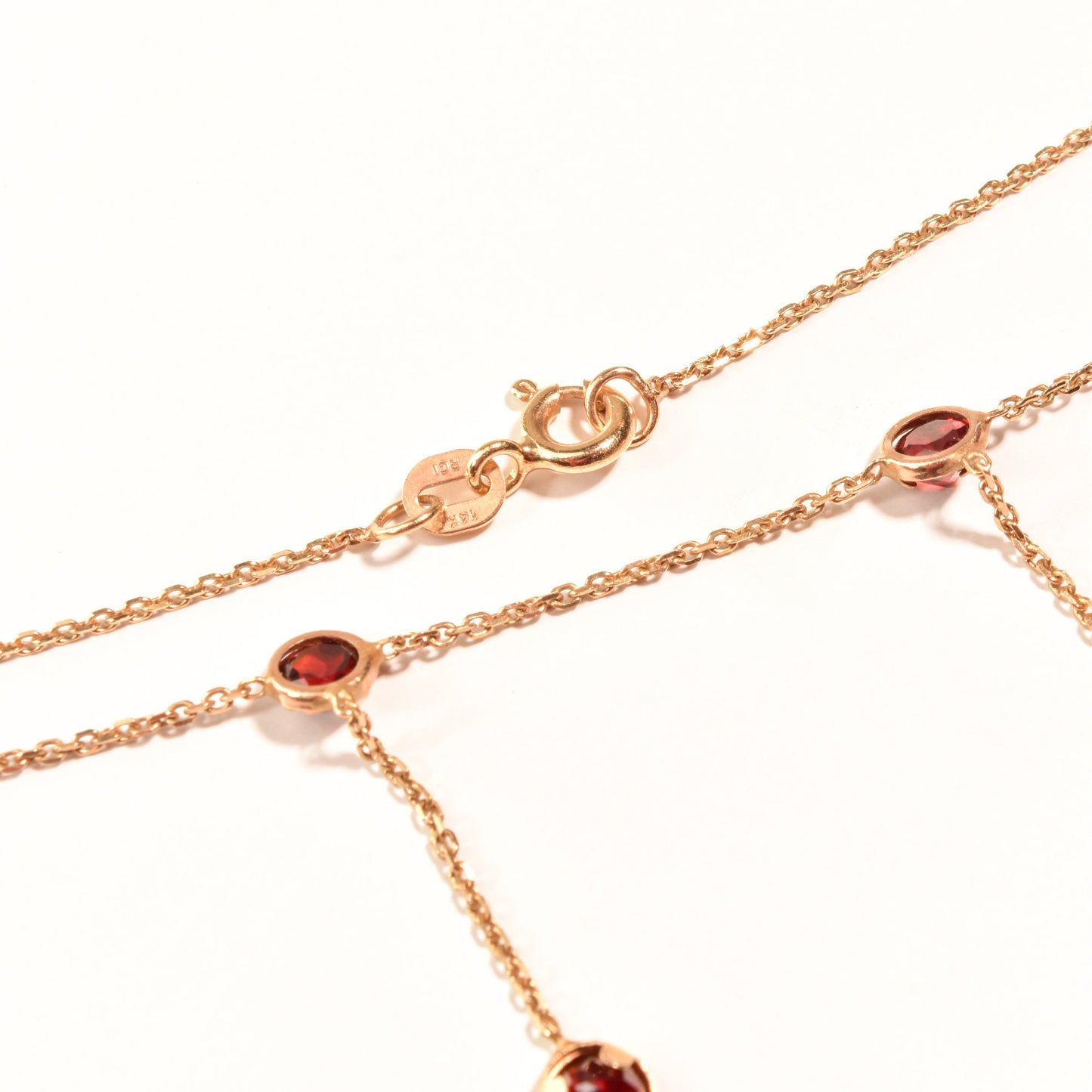 14K gold delicate chain necklace with garnet gemstone stations and dainty tassels, minimalist bezel-set drop style, 16 inch length, elegant jewelry for women.