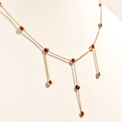 14K gold delicate chain necklace with garnet bezel-set stations and dangling teardrop pendants, elegant minimalist choker style, 16 inch length.