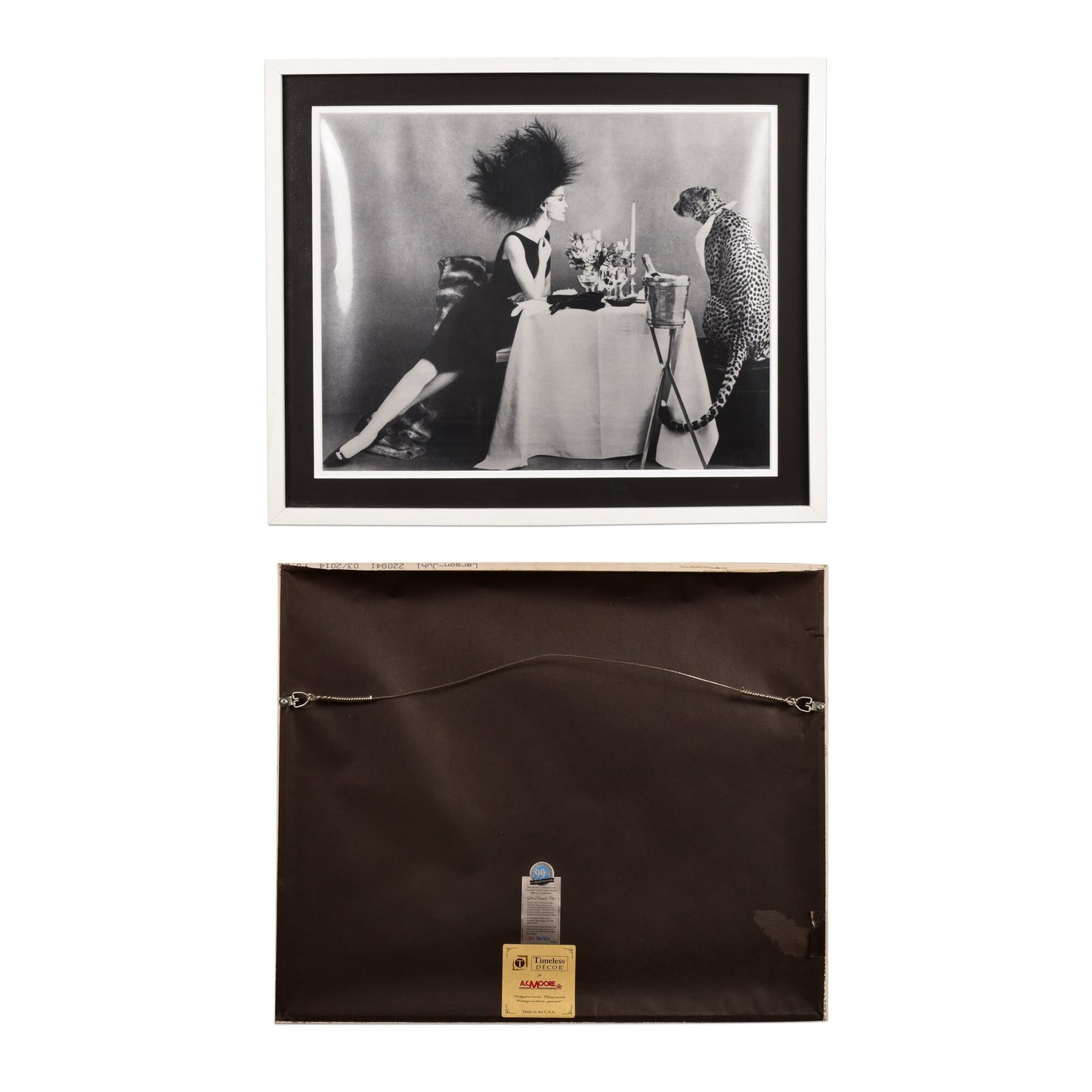 Black and white vintage photographs displayed in frames on a wall. The top photo shows a stylishly dressed woman at a dining table. The bottom photo is a still life of a small bottle or container on a dark surface, attached to the wall with a wire.