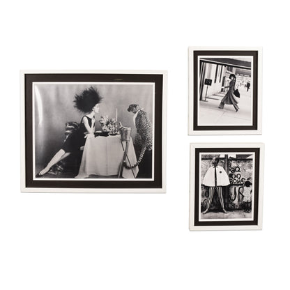 Framed black and white vintage Vogue magazine prints featuring fashionable women from past decades, displayed as stylish wall art decor.