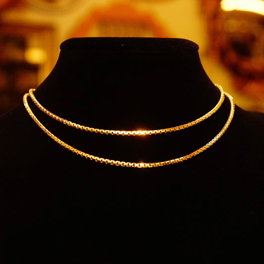 14K yellow gold Boston link chain necklace, 1.9mm heavy weight, 25 3/4 inches long, displayed on black velvet with warm ambient lighting