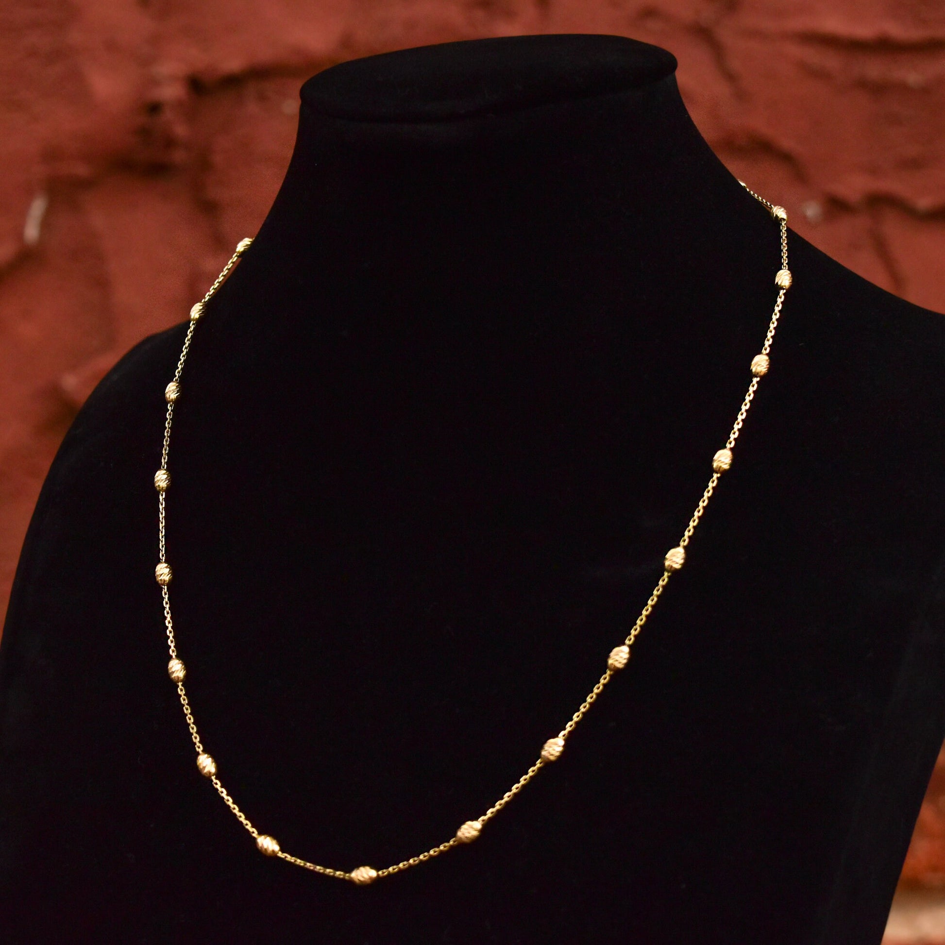 Italian vermeil sterling silver beaded station necklace with engraved honey dipper beads on black velvet display, 1mm cable link chain, 17 3/4 inches long.