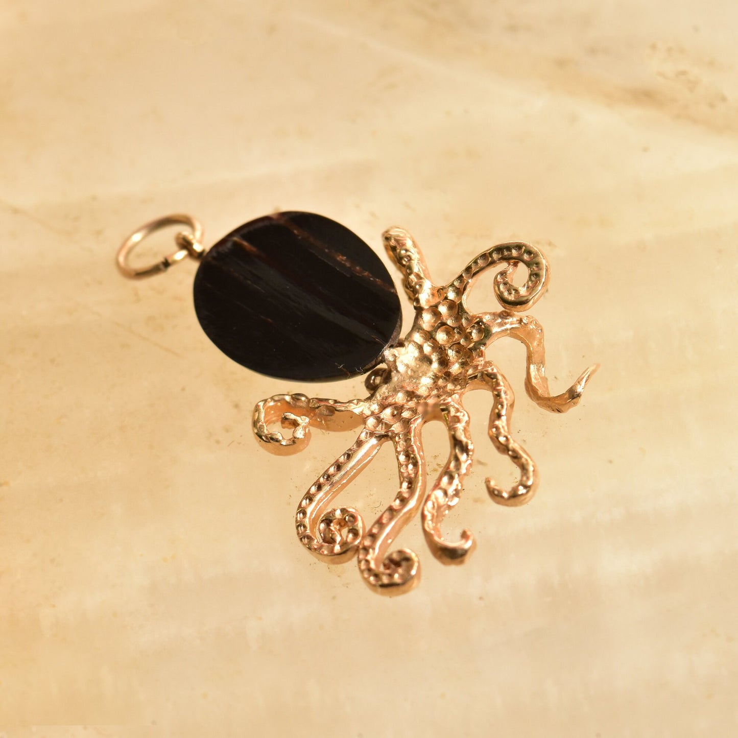 10K yellow gold octopus pendant with black coral body and diamond-encrusted accents, intricate 3D aquatic jewelry design