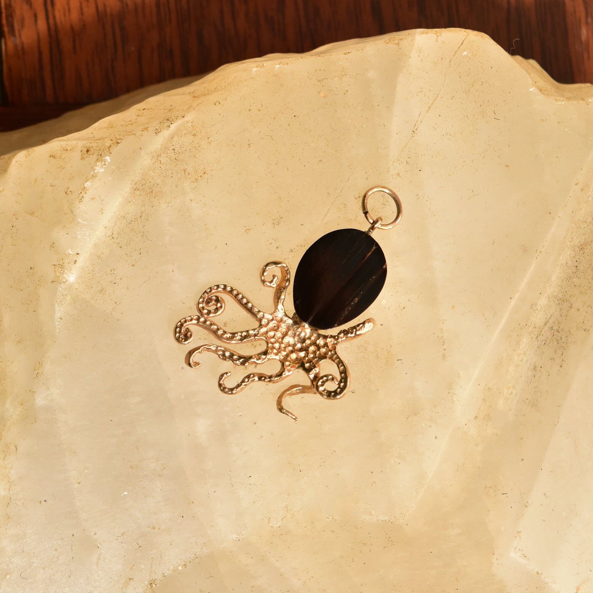 10K yellow gold octopus pendant featuring a black coral diamond eye, 3D design, aquatic jewelry theme, measuring 38mm in size.