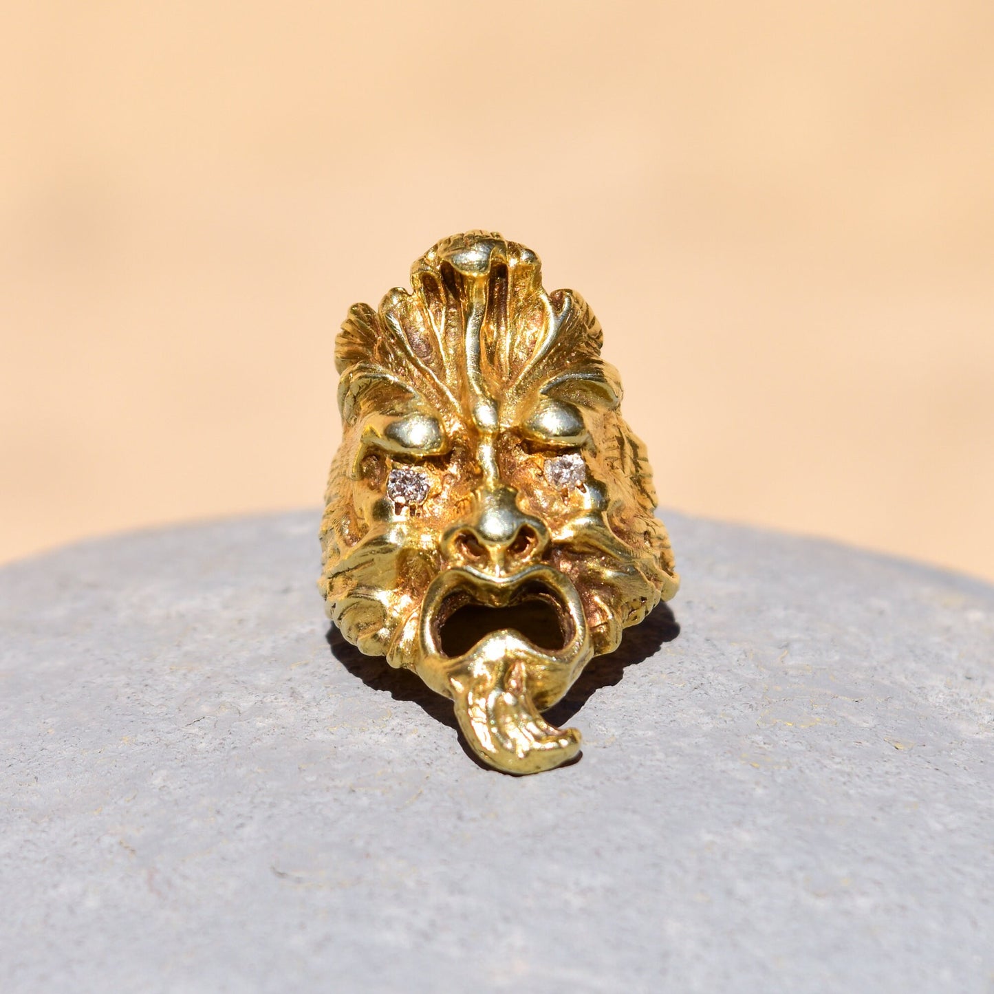 Solid 14K gold sculpted face men's ring with diamond eyes, crafted in a detailed mask design. A unique statement ring with .20 total carat weight diamonds, size 9 US.