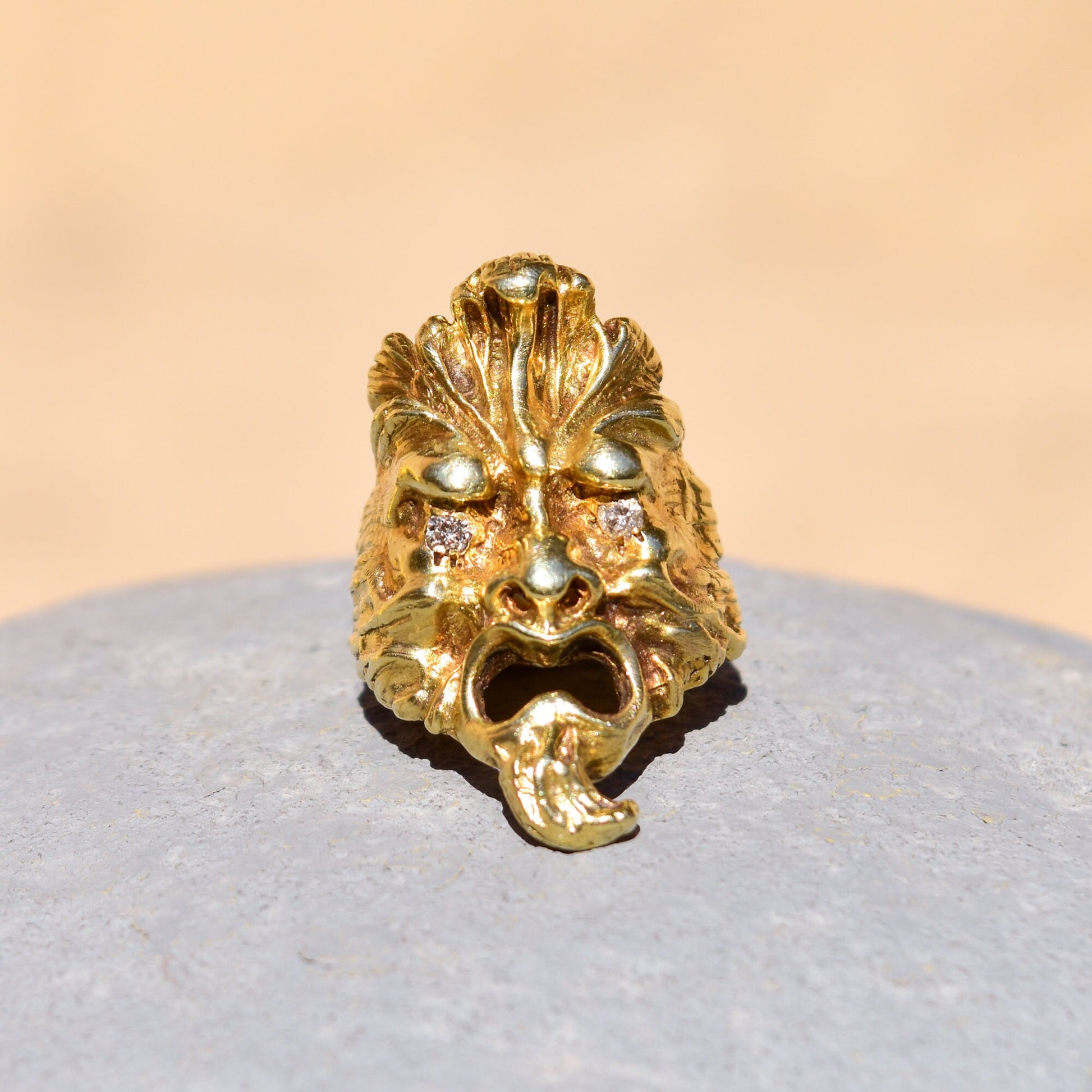 Solid 14K gold sculpted face men's ring with diamond eyes, crafted in a detailed mask design. A unique statement ring with .20 total carat weight diamonds, size 9 US.