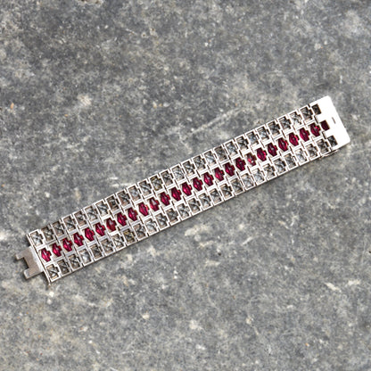 French Art Deco sterling silver bracelet with ruby paste stones in a wide articulated link cuff design, measuring 6 3/4 inches long, estate jewelry piece.