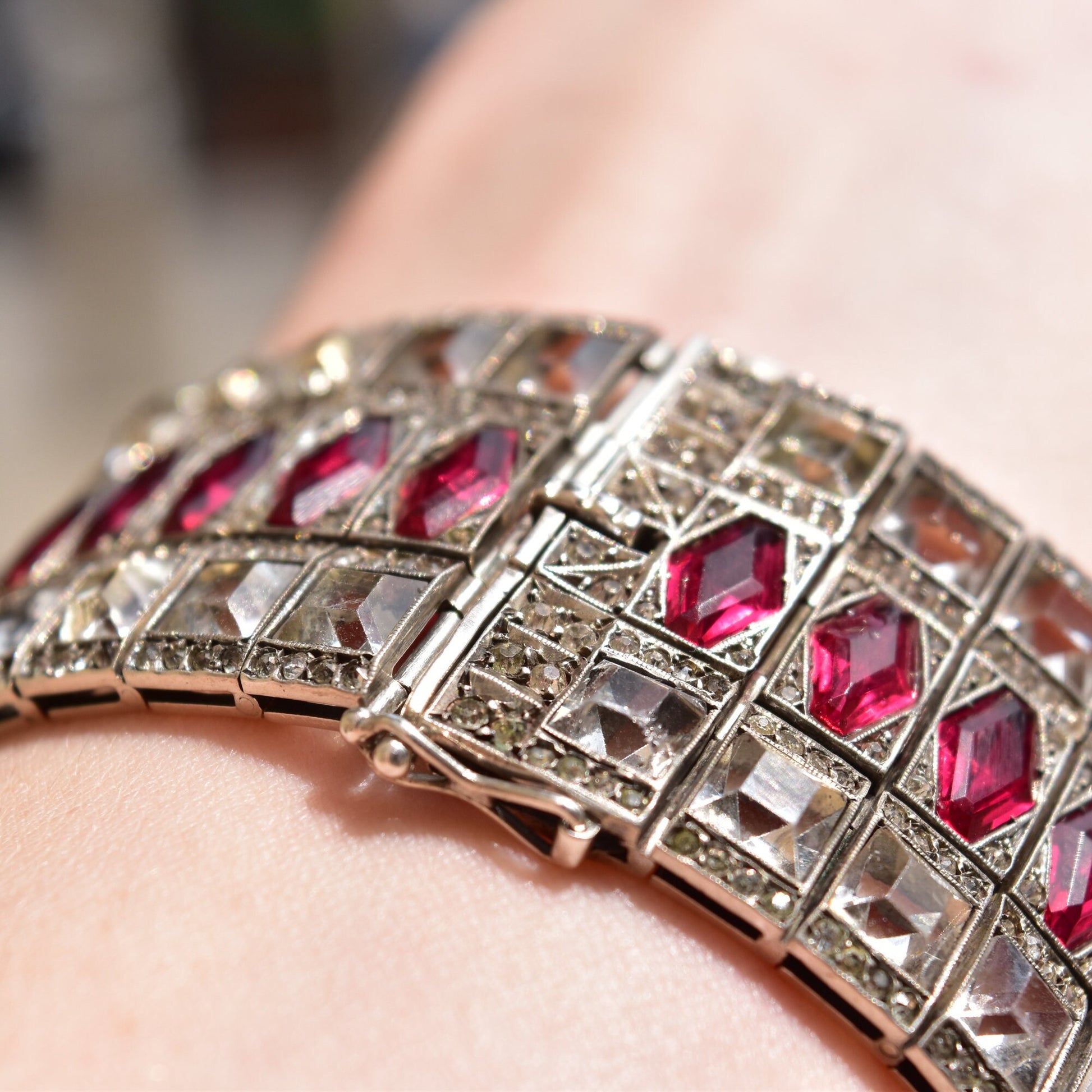 French Art Deco sterling silver hinged cuff bracelet with ruby red paste stones and articulated geometric design links, vintage estate jewelry 6 3/4 inches long.