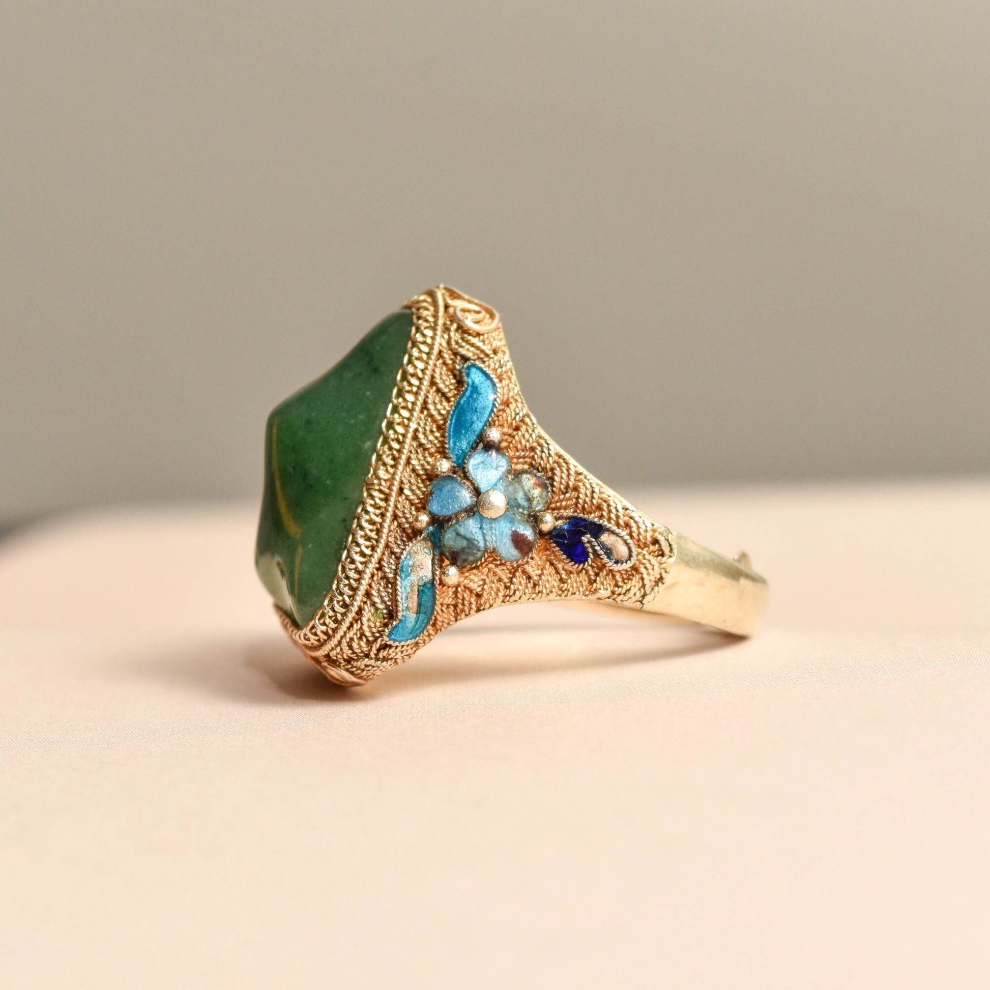 Ornate antique Chinese export vermeil silver ring with green enamel, blue gemstone nuggets, and decorative floral motifs on an adjustable band sized 7-11 US.