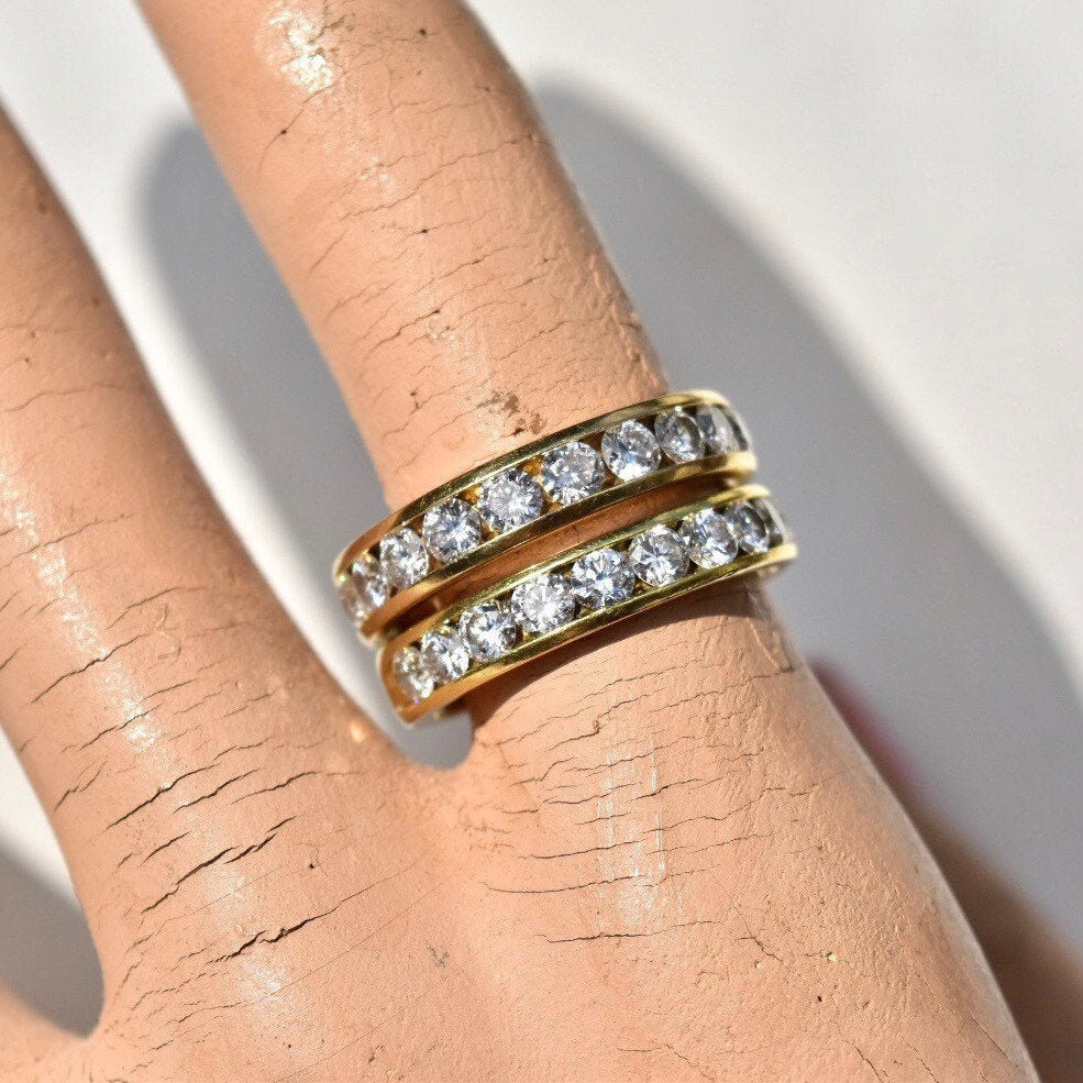 18K yellow gold channel set diamond half-eternity wedding band ring with 10 brilliant round diamonds, approximately 0.8 total carat weight, pictured on a hand, available in US ring sizes 7 and 7 1/4.