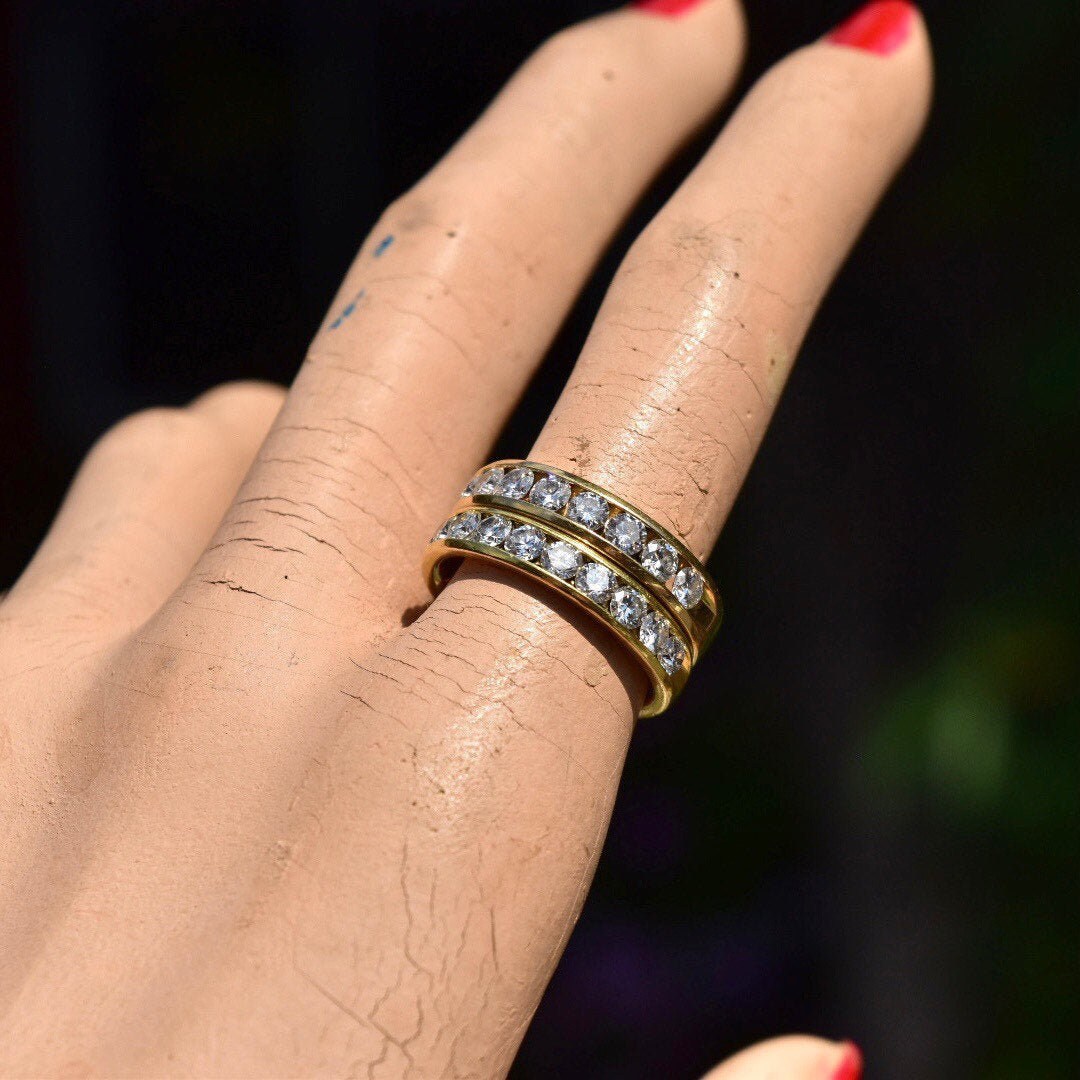 18K yellow gold half-eternity diamond wedding band with channel-set brilliant cut diamonds on model's hand