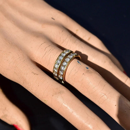 18K yellow gold channel set diamond half-eternity wedding band with 10 brilliant round diamonds on a woman's hand