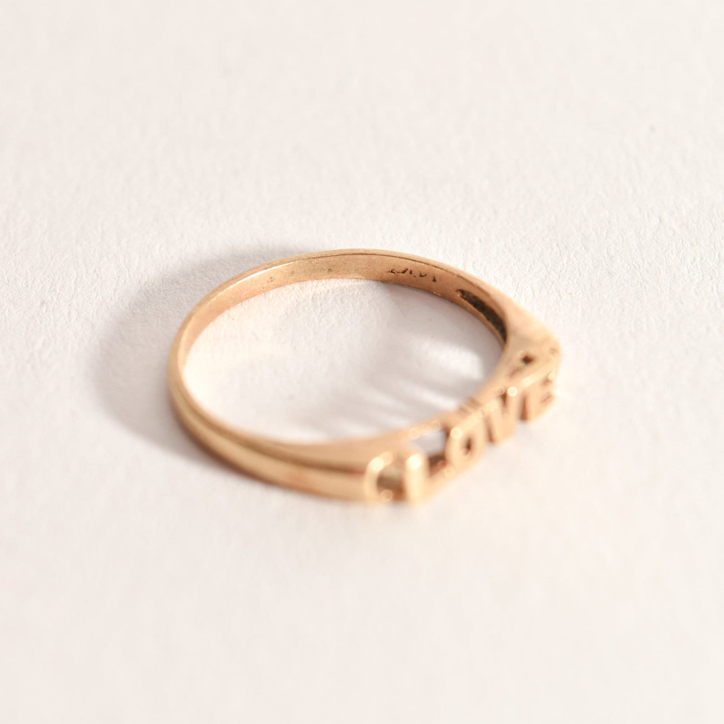 14K yellow gold minimalist 'LOVE' ring, cute gold stacking ring for Valentine's Day gift, size 6.75 US displayed on a clean white background.