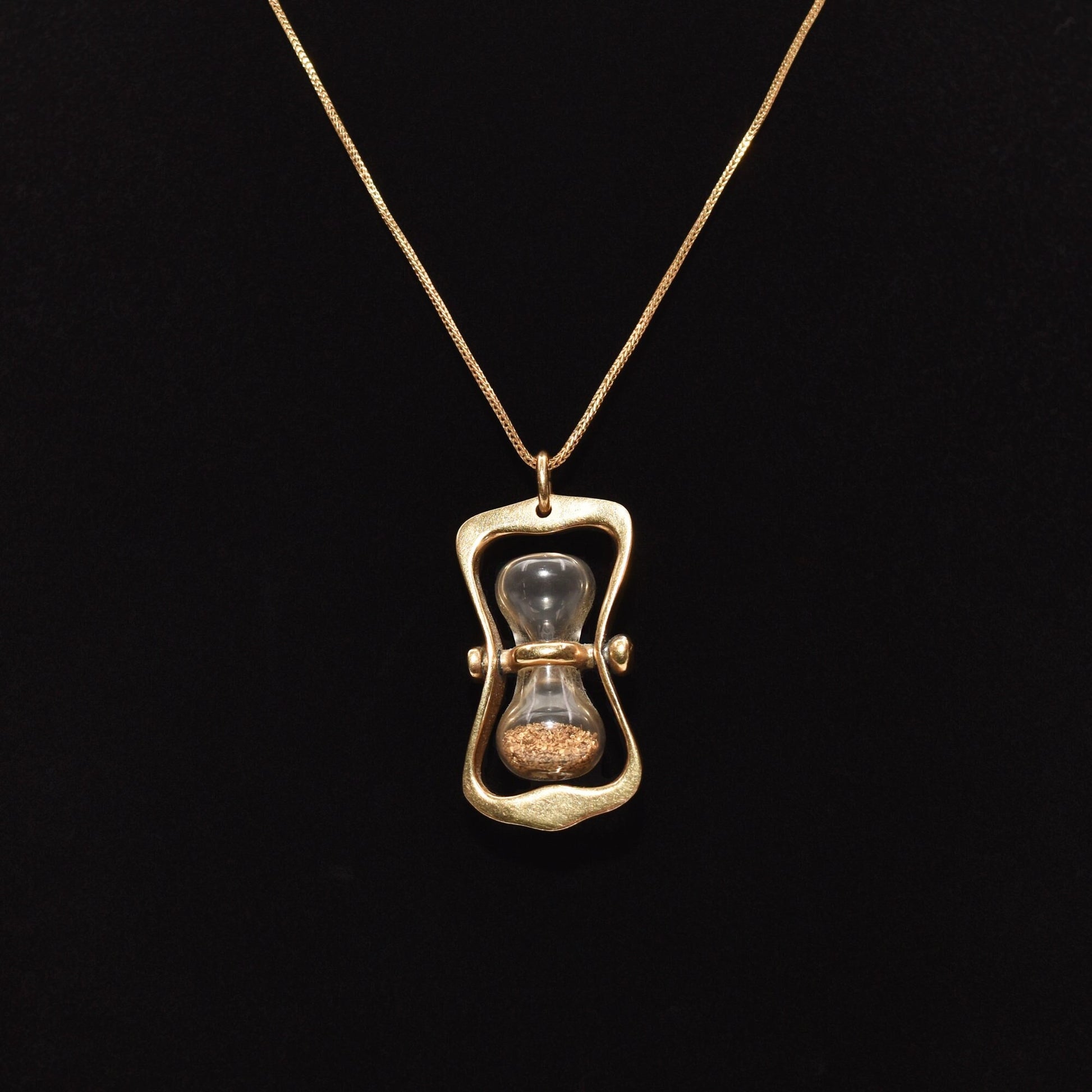 14K gold hourglass pendant with gold dust on a black background, 36mm movable swivel estate jewelry