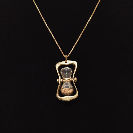 14K gold hourglass pendant with gold dust on a black background, 36mm movable swivel estate jewelry