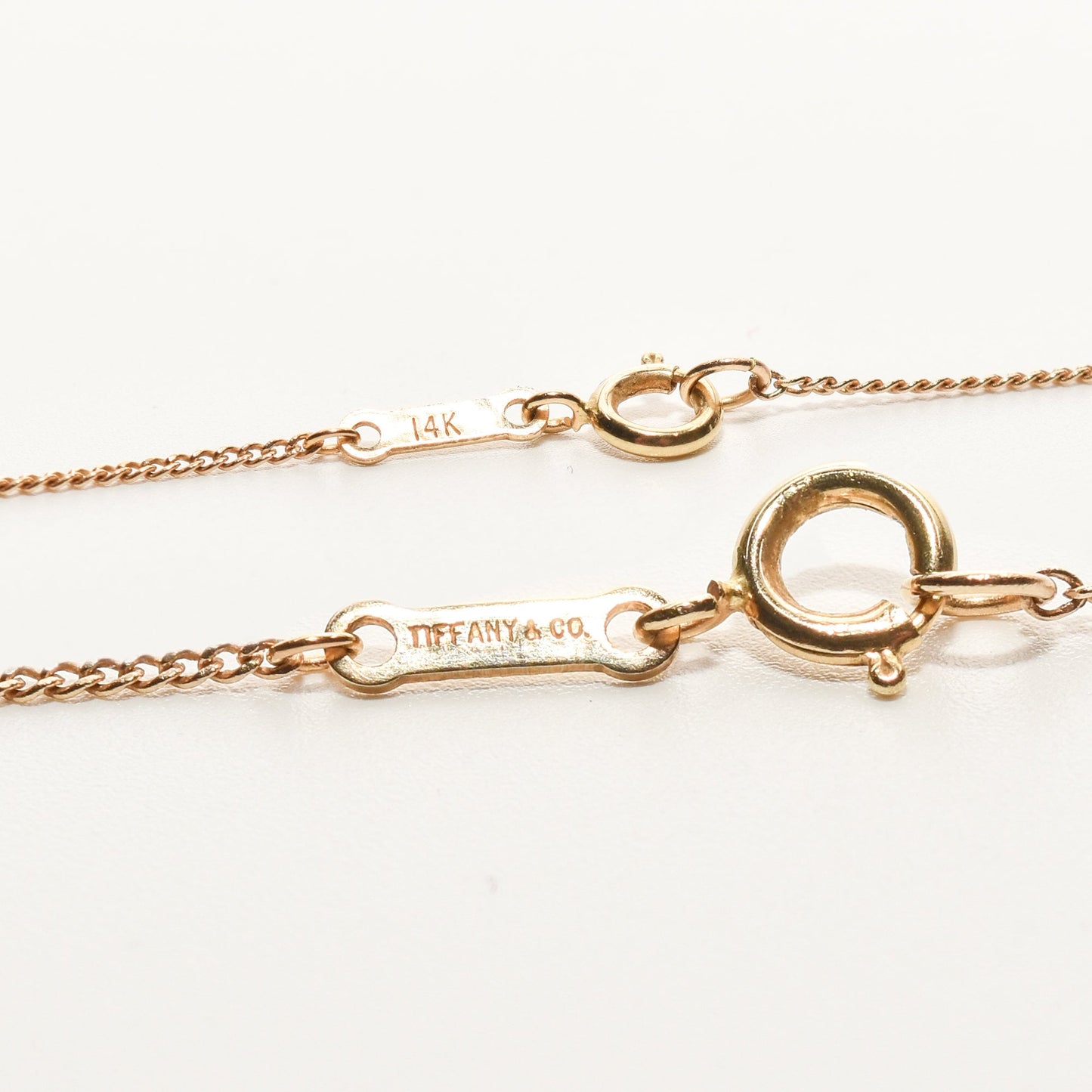 14K gold Tiffany & Co. lapis lazuli heart cross pendant on an 18-inch chain, minimalist gemstone necklace.