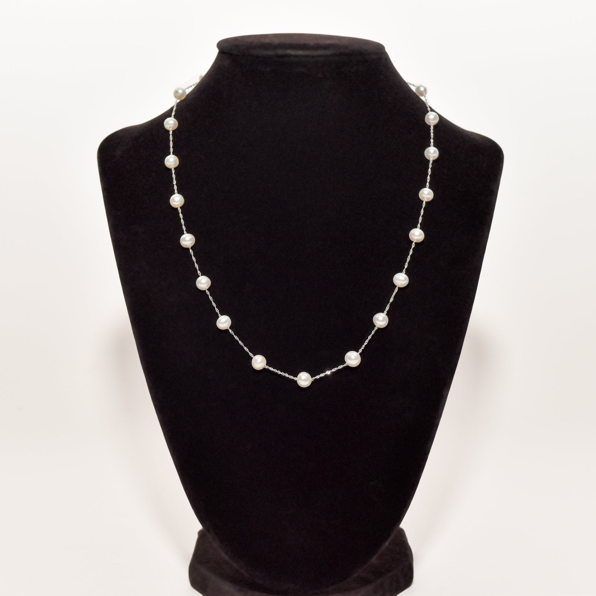 White pearl choker necklace in 14K white gold on black display stand, elegant pearl station necklace at 17.75 inches length.