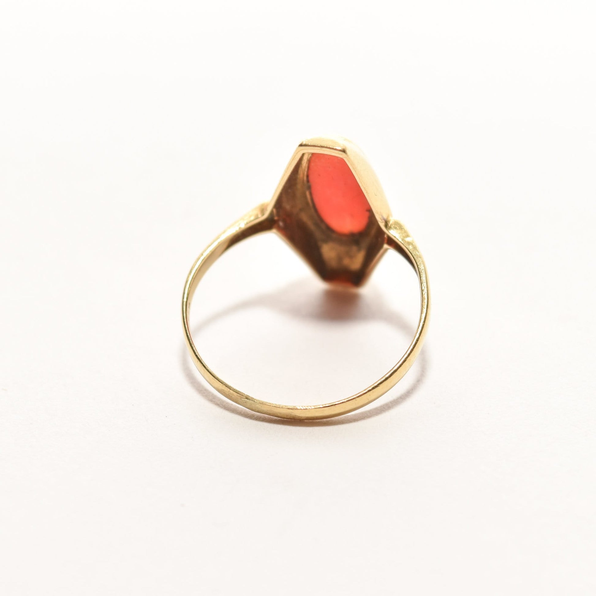Estate 18K coral marquise ring displayed on a white background, featuring a yellow gold band with a red coral inset, size 5.25 US.