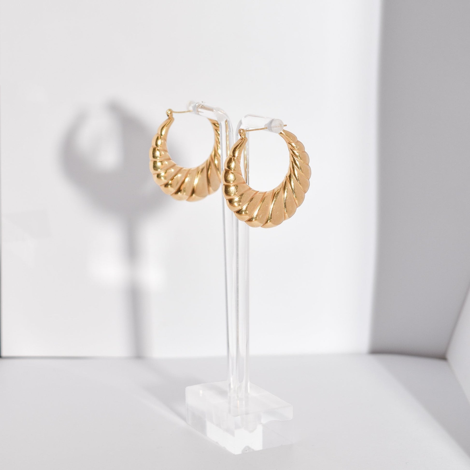 MCM 14K yellow gold puffed scallop hoop earrings, medium-sized 36mm estate jewelry on display stand.