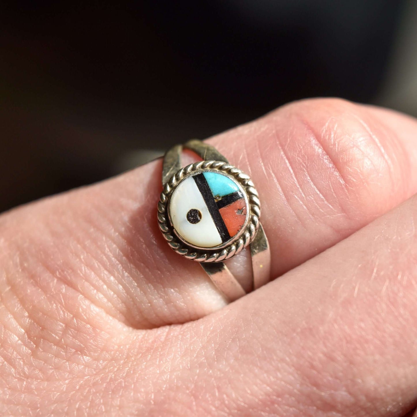 Sterling silver Little Zuni Sun Face ring with inlaid stone details worn on finger, Native American jewelry, size 5.25 US, shown for stacking ring inspiration.