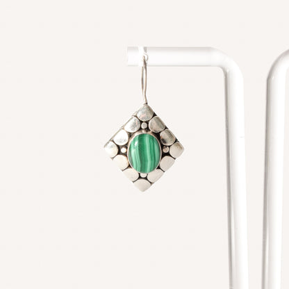 Sterling silver modernist earrings with malachite stone, 1.5 inch dangle gemstone earrings on white display.