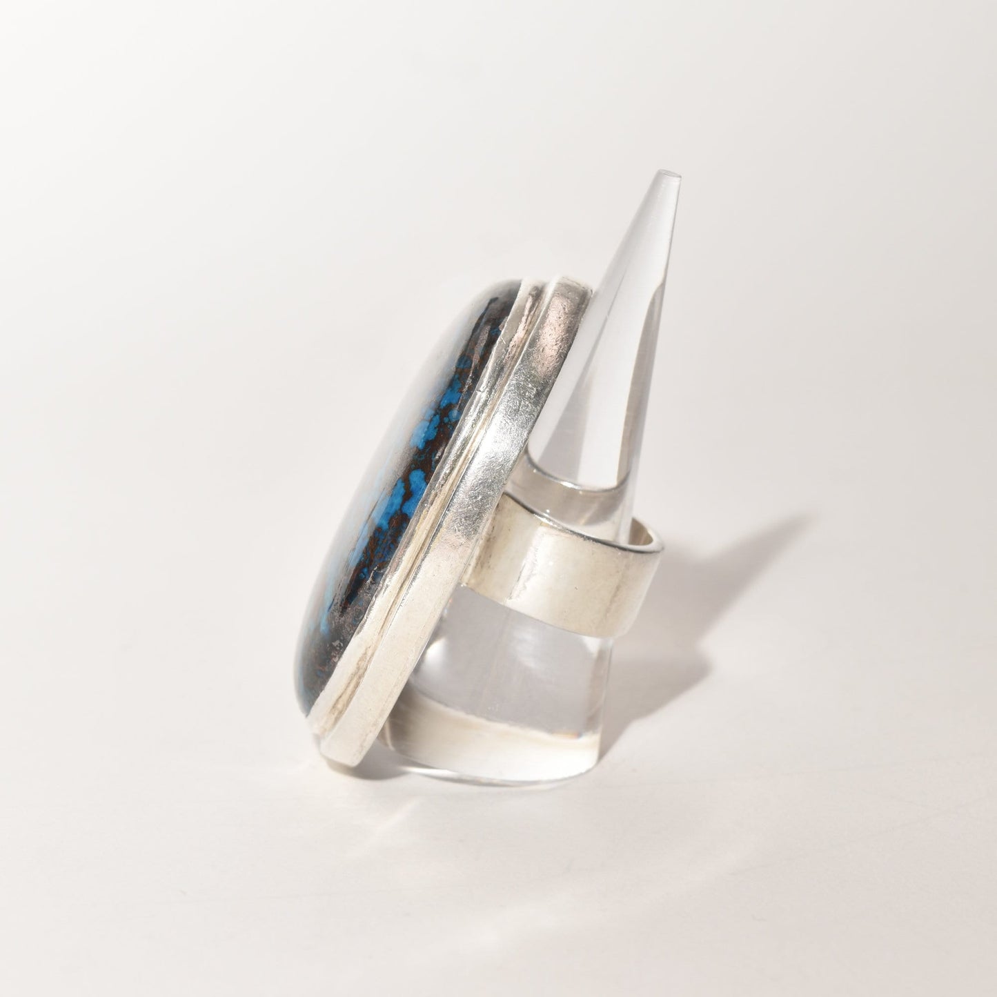Huge sterling silver statement ring with blue matrix cabochon gemstone, size 7 3/4 US, on white background.