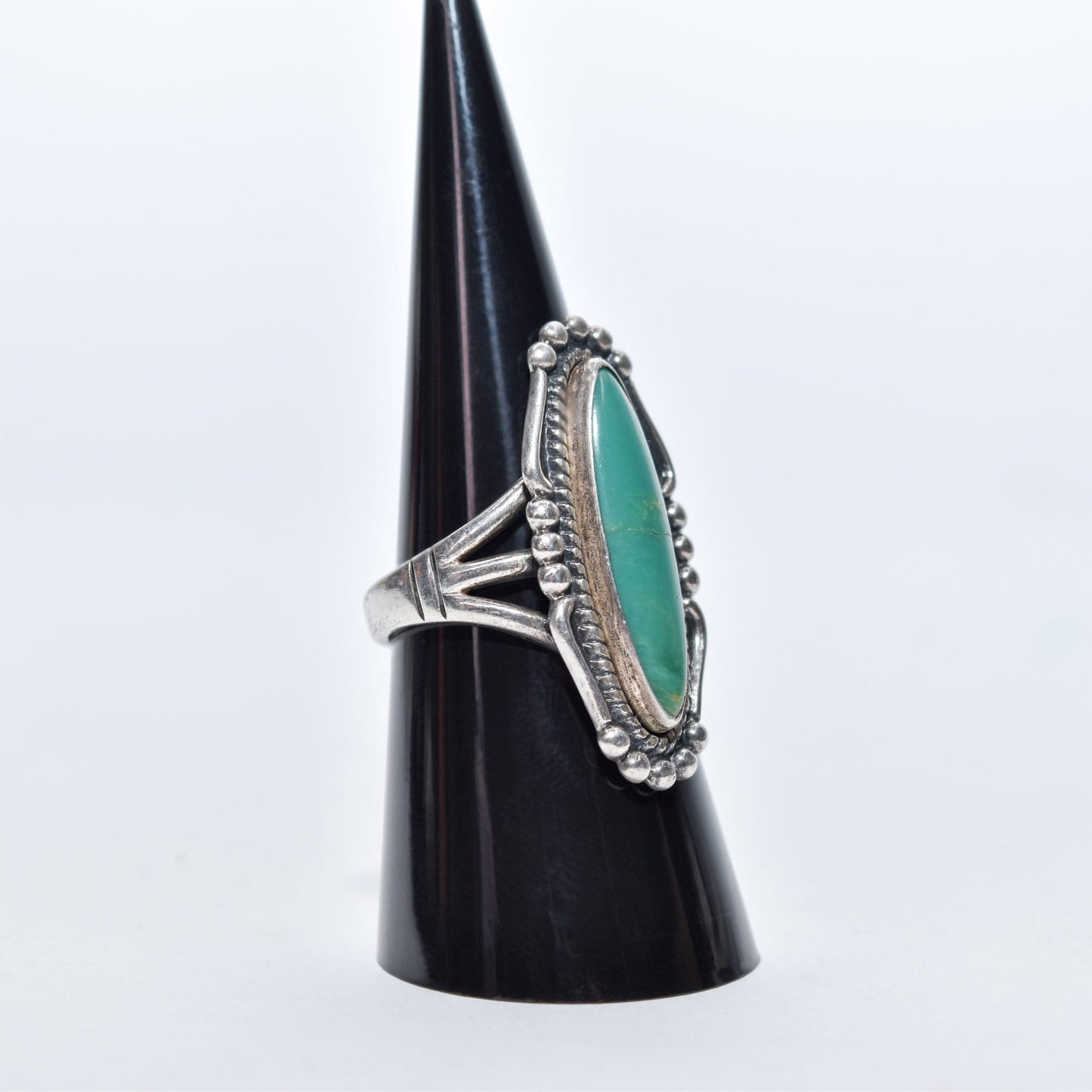 Native American sterling silver turquoise marquise ring on a display, Southwestern jewelry, size 8 US, on a white background.