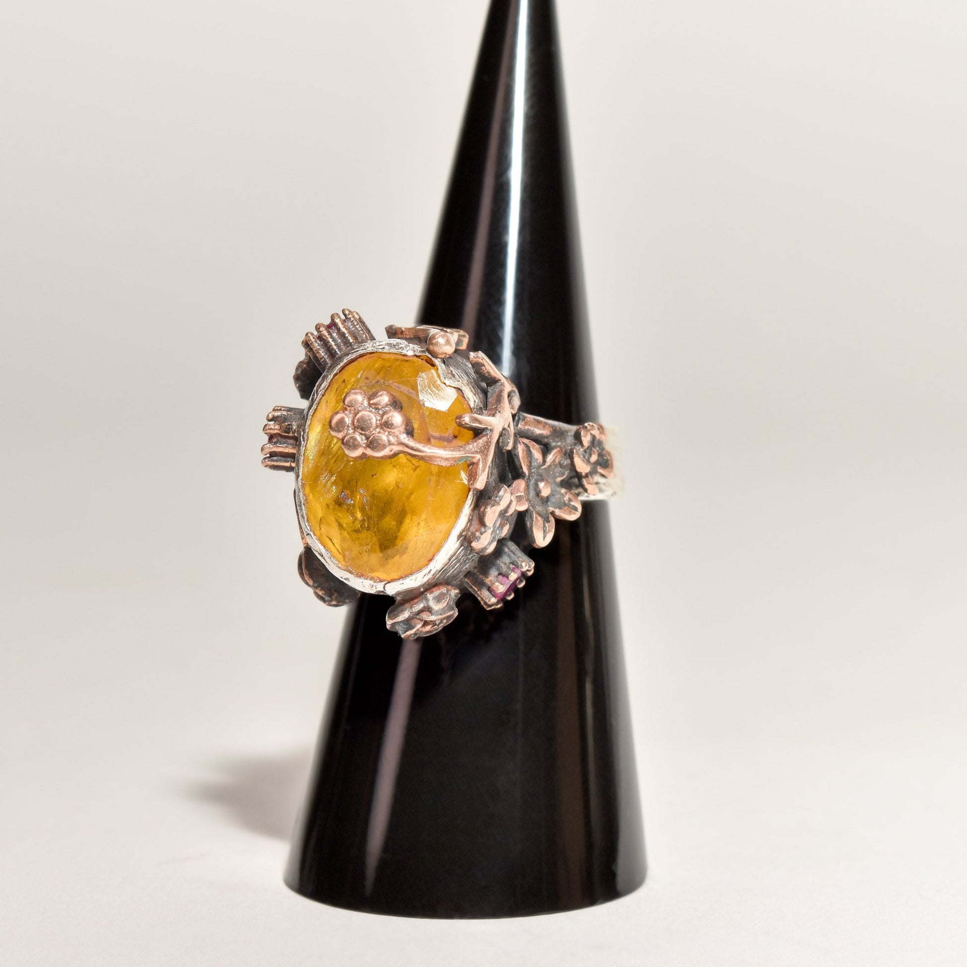 Brutalist sterling silver citrine ruby flower ring, two-tone statement piece, size 6.25 US displayed on black cone stand.