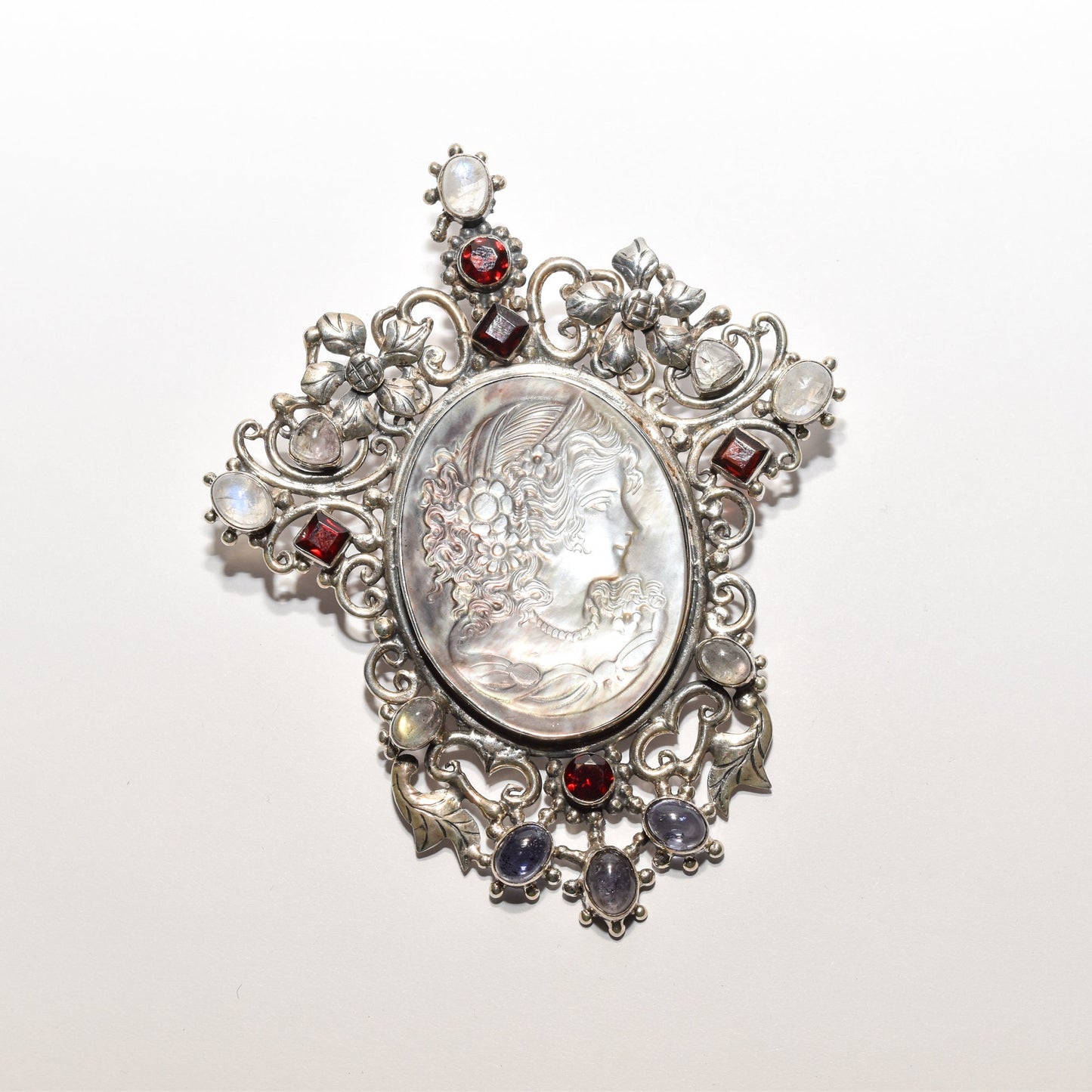 Victorian style sterling silver cameo pendant brooch with ornate multi-stone design and large profile centerpiece, measuring 4 inches in length.