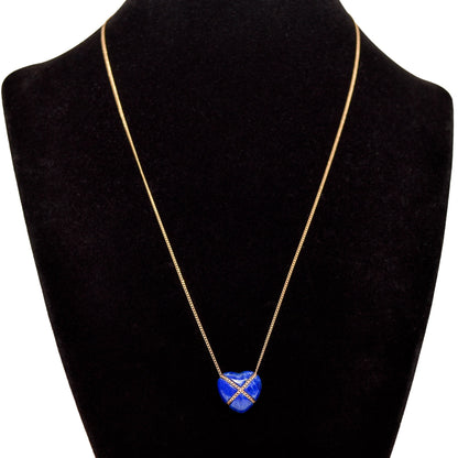 Alt text: "Elegant 14K gold Tiffany & Co. necklace featuring a lapis lazuli heart-shaped pendant with a cross design on a black display, showcasing a minimalist gemstone necklace with an 18-inch length.