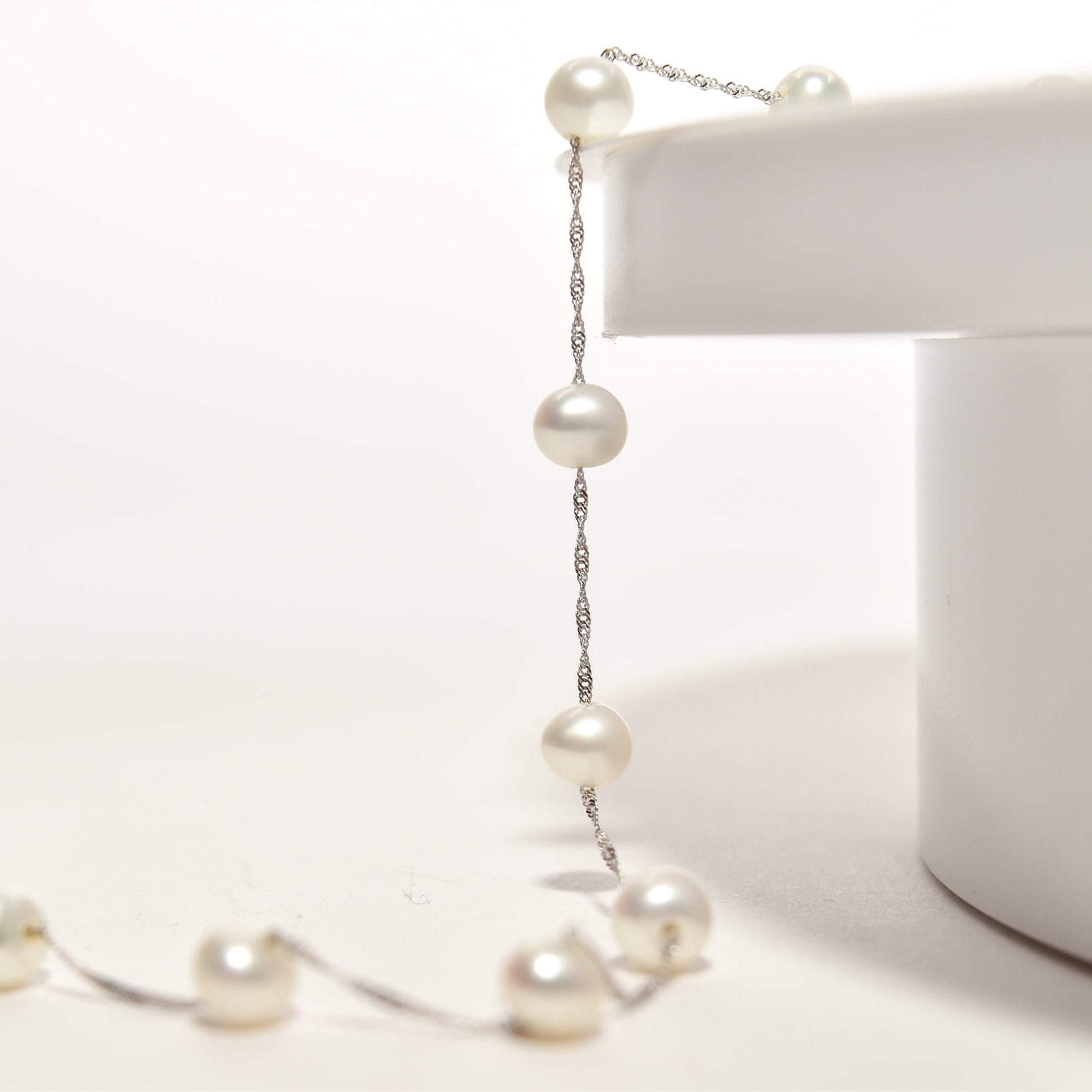 Elegant white pearl choker necklace in 14K white gold with pearl station design on a 17.75-inch chain, displayed on a white background.