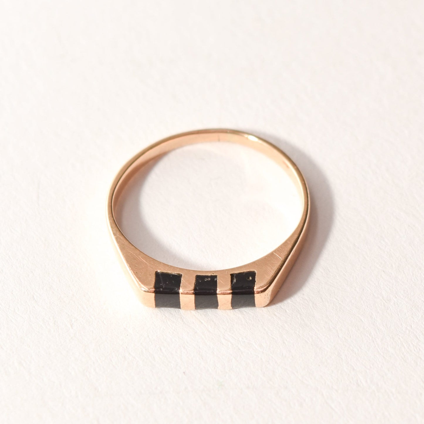 Minimalist 14K yellow gold stacking ring with black onyx inlay, size 5.5 US, on white background.