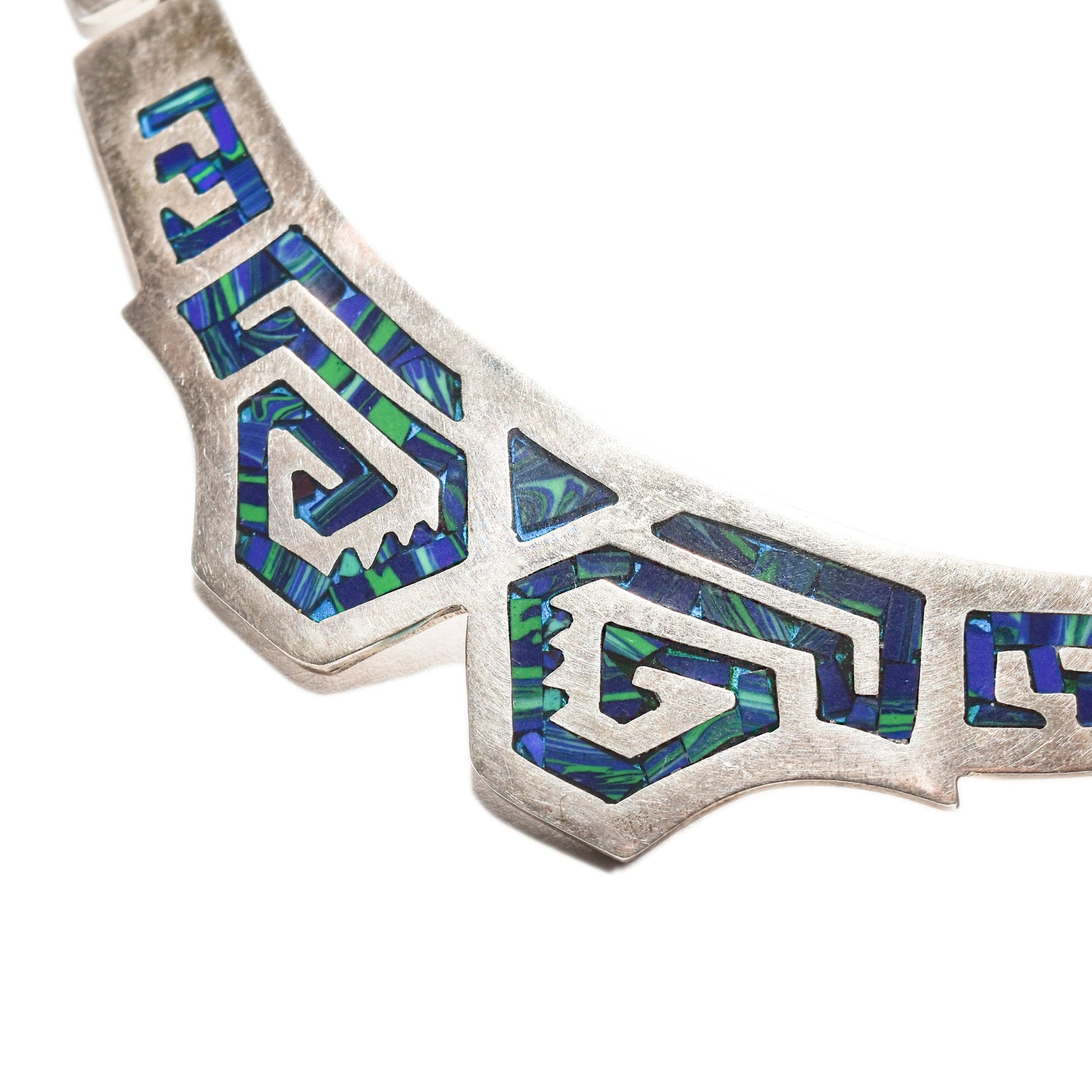 Modernist TAXCO sterling silver collar necklace with blue and green mosaic inlay in a tribal design, measuring 17.5 inches in length.